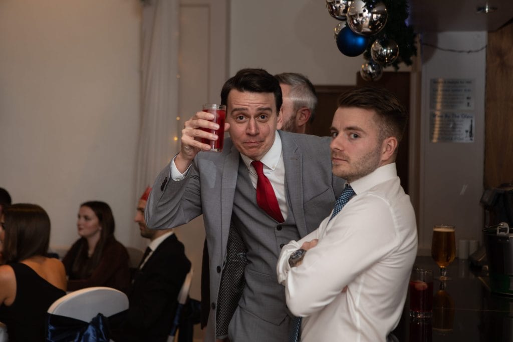 two men posing for a photo at a christmas party in kent