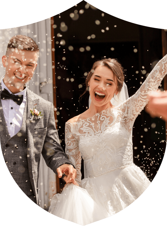 Man and woman celebrating their wedding in kent with confetti and holding hands