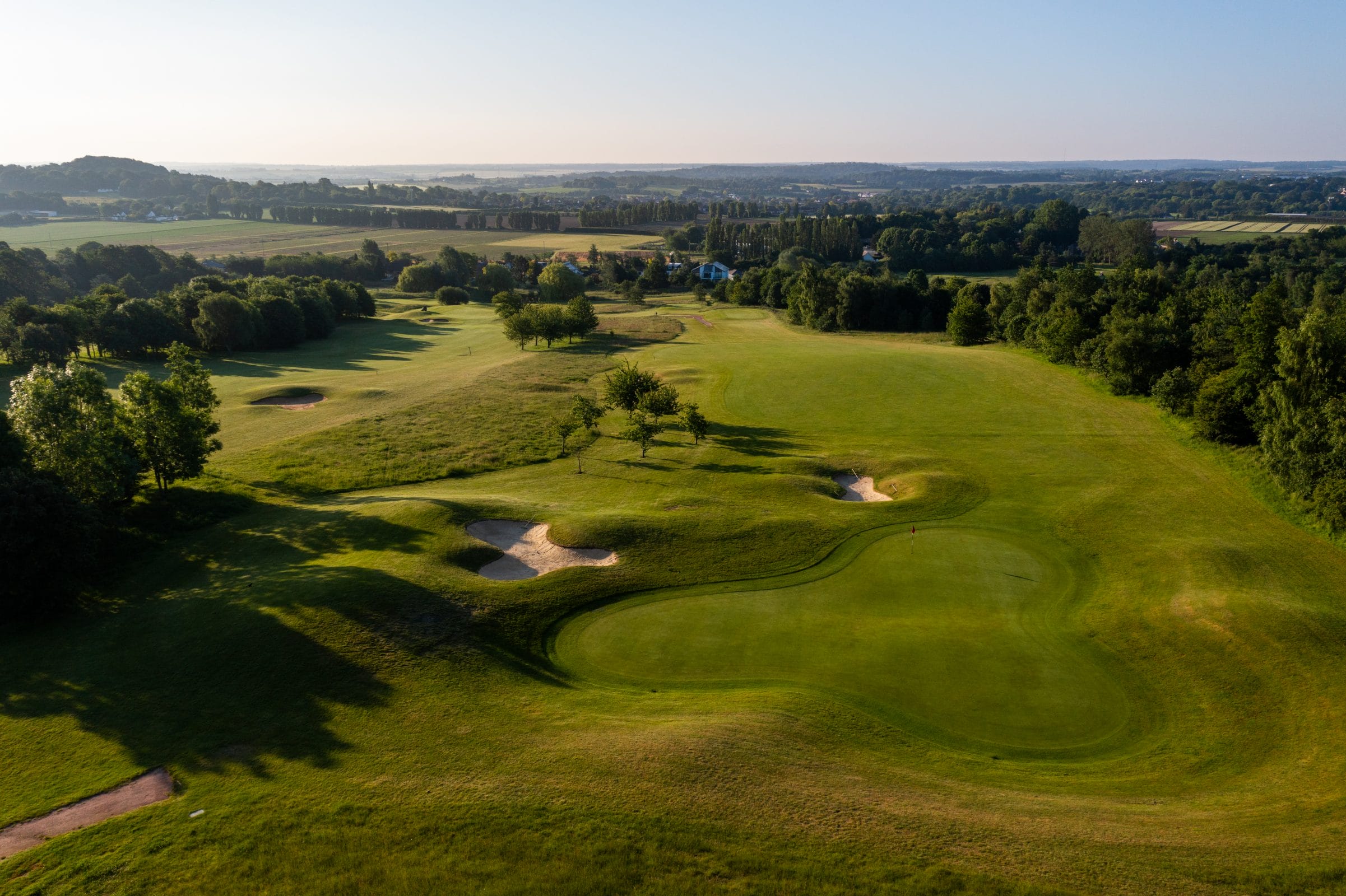 aerial shot of golf course in kent at birchwood park with luscious grass and golf holes