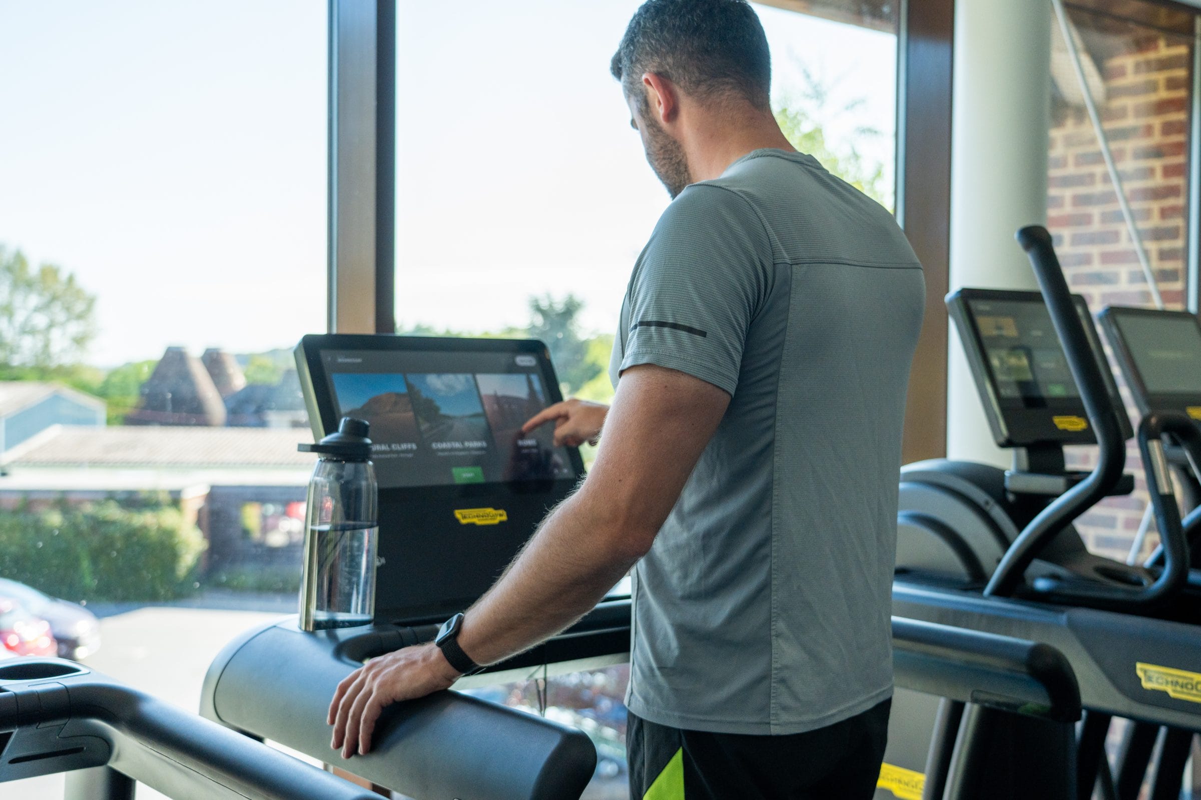 gym member setting treadmill speed at country club in kent