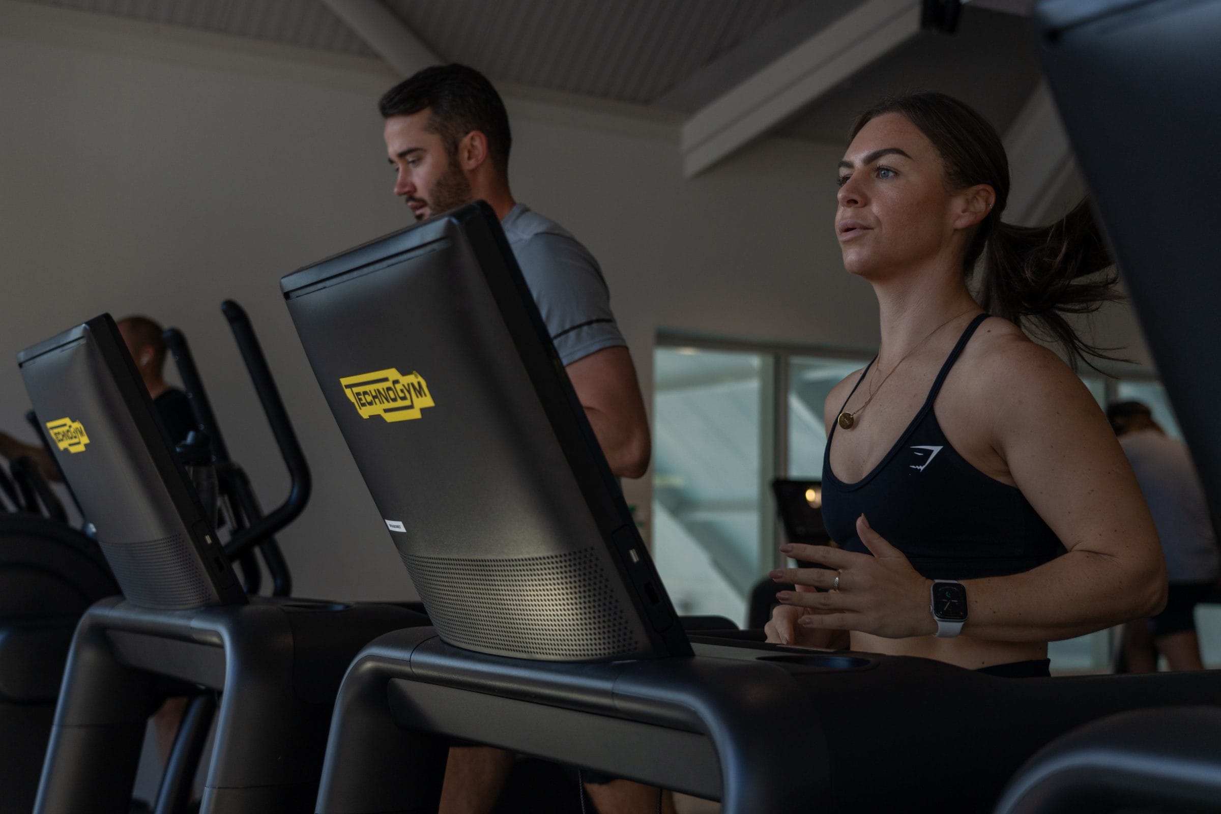 Woman and man on Technogym treadmill exercising at gym in dartford