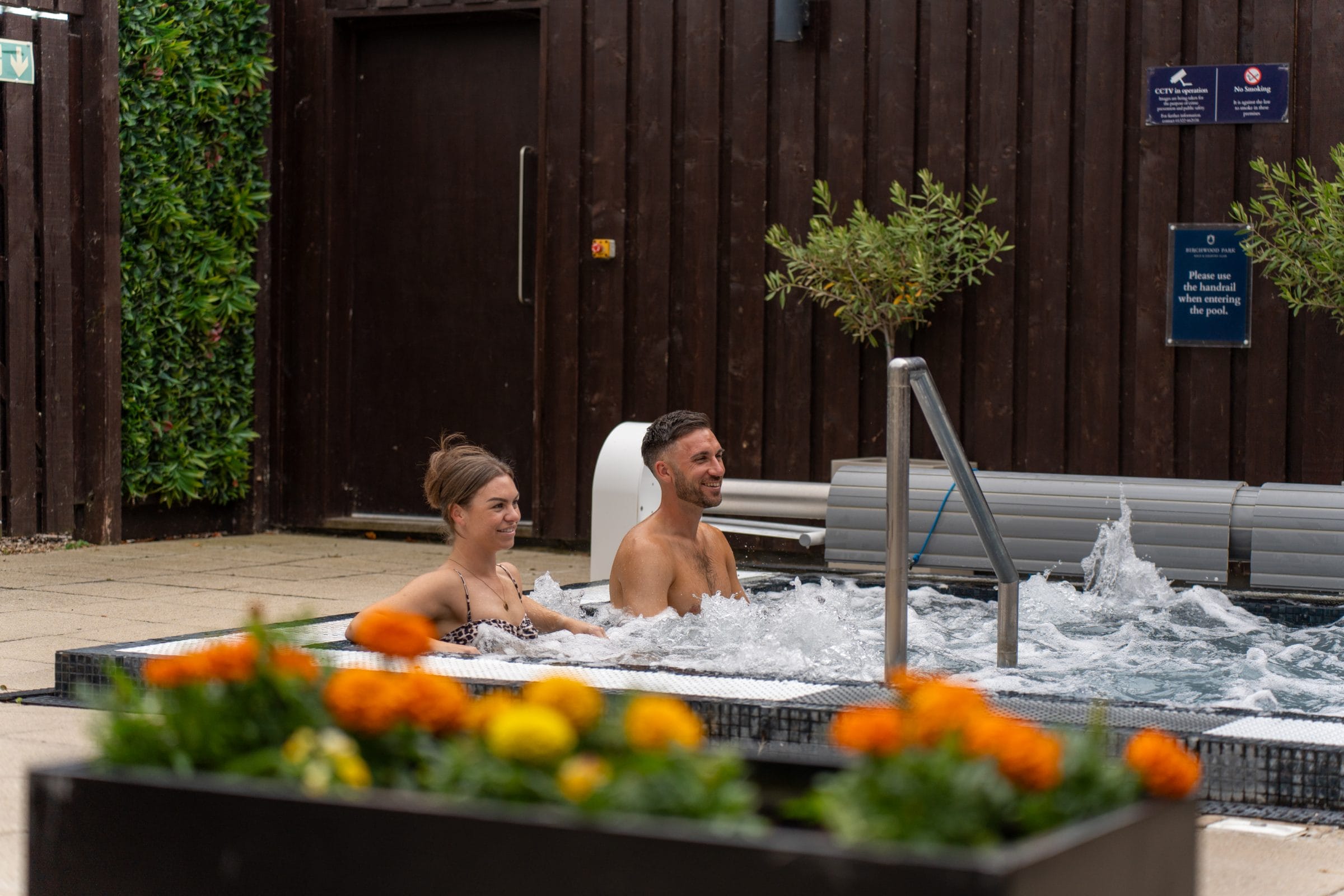 Man and woman relaxing in outdoor hot tub at gym in dartford