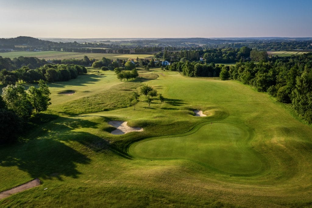 Aerial view of Birchwood Golf and Country Club’s scenic fairways and bunkers on a clear day