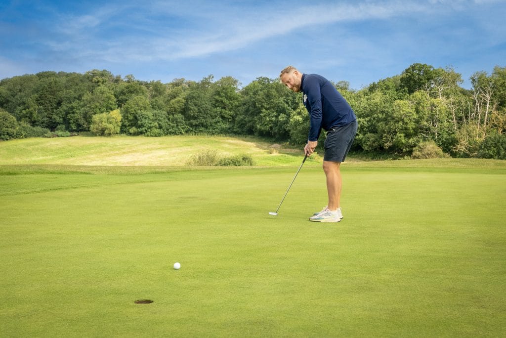 golfer putting on a large well manicured green at golf club in kent