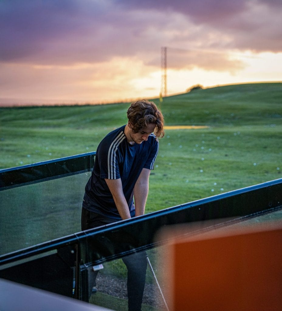 Person on the driving range at sundown in kent