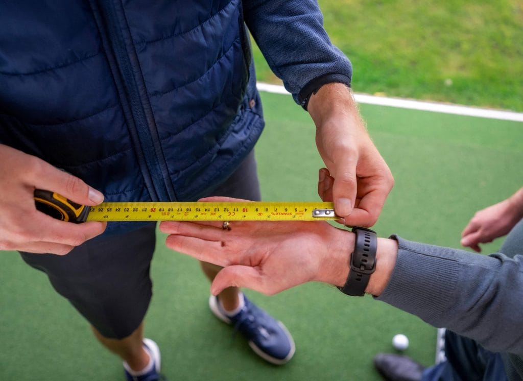 Measurement of hand during a custom fit consultation